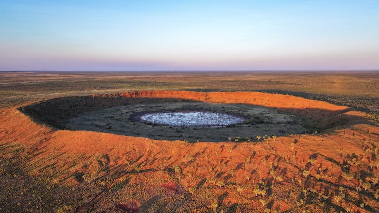 A breathtaking aerial view of the iconic Wolfe Creek Crater in Halls Creek, Australia.
