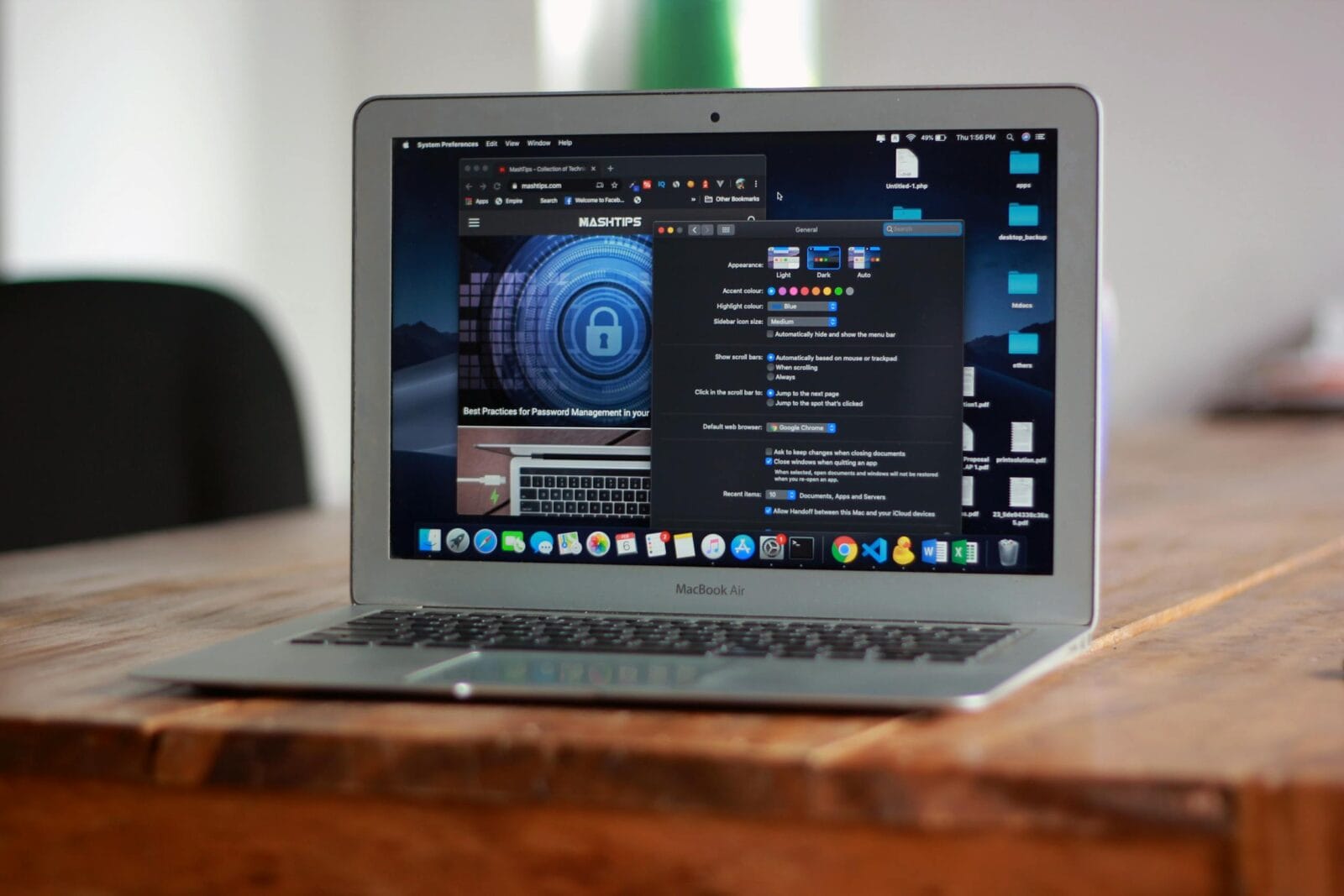 Open MacBook Air with apps and web browser on screen, placed on a wooden table indoors.